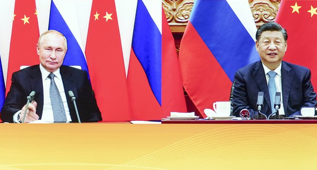 Chinese President Xi Jinping and Vladimir Putin hold virtual summit; vows to support each other's national interest