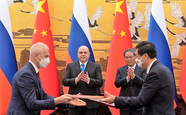 Russia's PM signs set of agreements with China today during trip to Beijing, describing bilateral ties at an unprecedented high