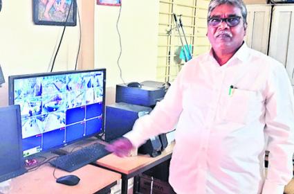 HM Gopalam showing the CCTV footage on the computer   Security cameras ensure safety of female students in schools  Parents and students appreciate government's safety measures