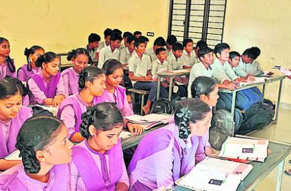 Teacher clearing the doubts of students in Ramabhadrapuram High School