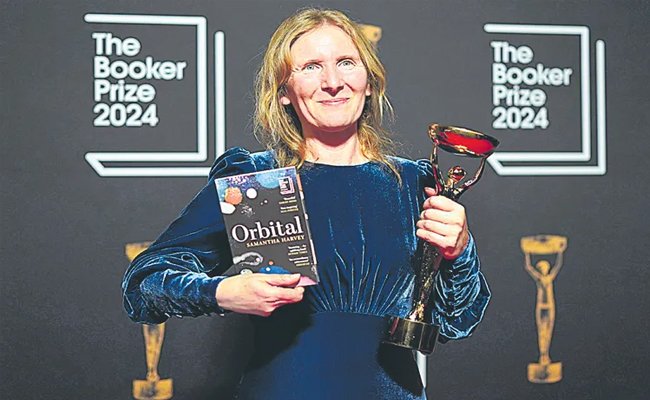 British author samantha harvey receives booker prize with her novel  Samantha Harvey holding 2024 Booker Prize trophy 