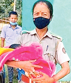 Assam police officer holding baby