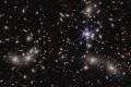 Hubble Views Massive Galaxy Cluster Warped by Gargantuan Magnifying Glass