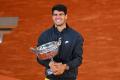 Carlos Alcaraz wins French Open for third Grand Slam title  Carlos Alcaraz lifting the French Open trophy in celebration